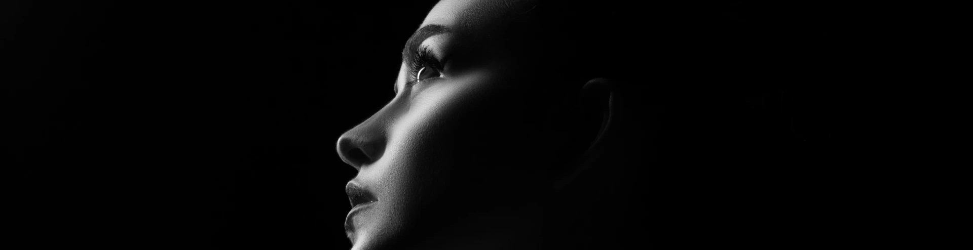 A black and white photo of a woman's face.
