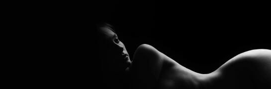 A black and white photo of a naked woman.
