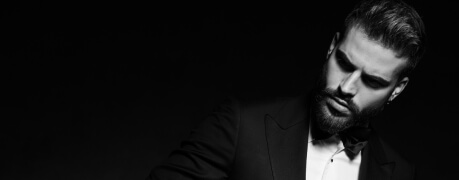 A black and white photo of a man in a tuxedo.