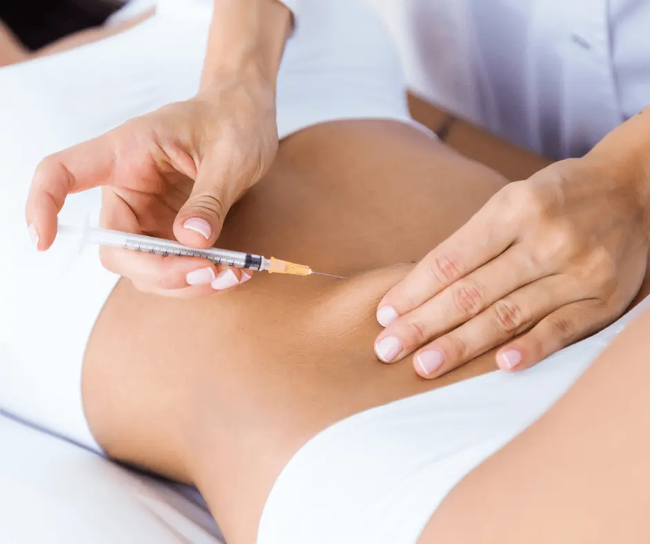 An awake woman receiving an injection on her stomach.