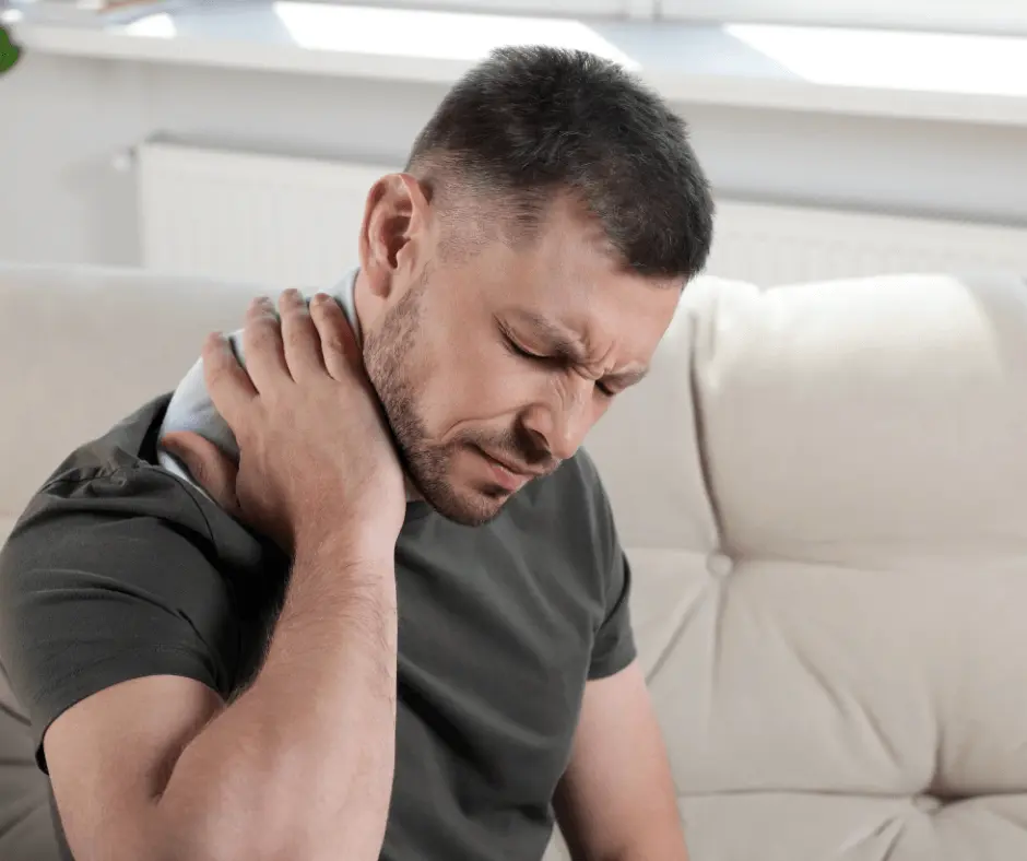 A man with a neck pain and Buffalo Hump is sitting on a couch.