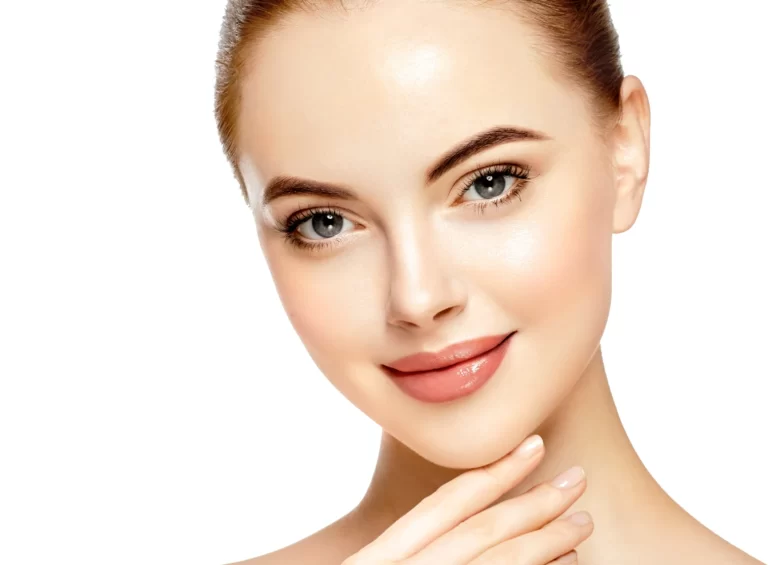 A young woman with defined facial features and beautiful skin gently resting her hand on her face.