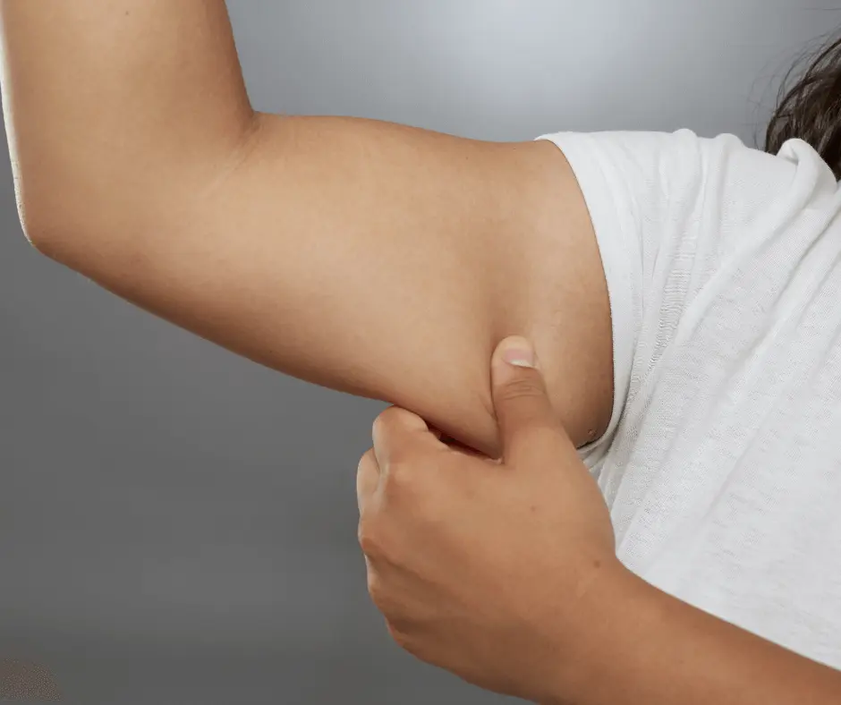A micro gesture of a woman touching her arm with her hand.