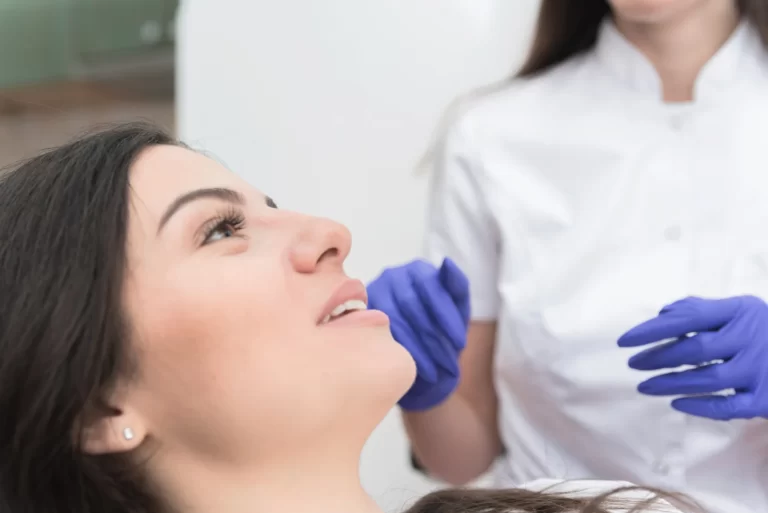 A woman is undergoing consultation to minimize swelling after chin liposuction.