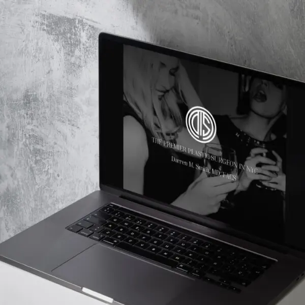 A laptop computer displaying a woman's face.