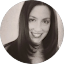 A black-and-white portrait of a woman with straight, dark hair, smiling at the camera—perfect for showcasing client reviews or testimonials.