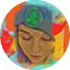 A person wearing a gray beanie with a green emblem looks downward against a colorful, abstract background, as if reflecting on heartfelt reviews.