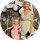 A woman in a light green dress stands smiling next to a young girl in a pink dress outdoors, surrounded by greenery and white flowers—the perfect backdrop for glowing reviews or heartfelt testimonials.