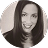 Professional black and white headshot of a woman with long, straight hair, smiling at the camera—a welcoming representation of Our Practice.