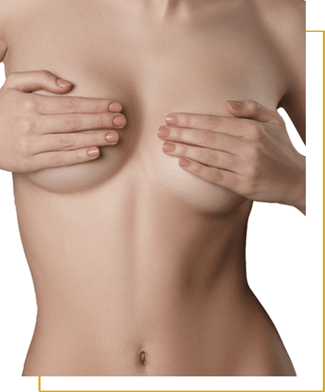 A woman covers her bare chest with both hands, standing against a plain white background.